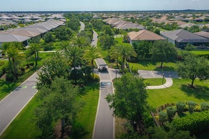 Scenic view of the Paseo Greenway in GL Homes’ Riverland community in Port St. Lucie, featuring a landscaped walking path.