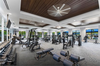 Interior view of the fitness center at a GL Homes community in Naples, showcasing modern exercise equipment and wellness amenities for residents.